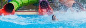 three slides at the water park rolls out of the middle child, splashing water